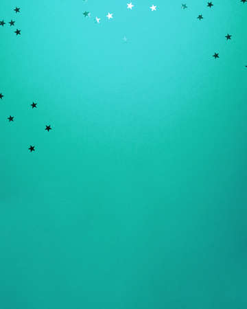 Cyan stars shapes at the top on cyan background. Christmas winter holiday concept flat lay top view with copy spaceの写真素材