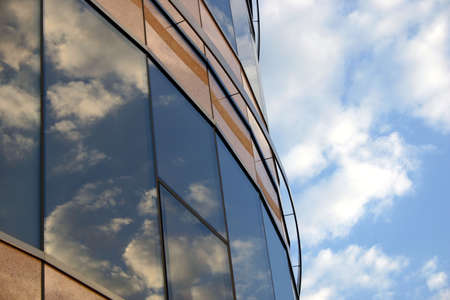 Corporate building and the sky. Reflections of the clouds on the windows