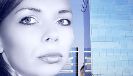 Businesswoman against the office building, toned in metallic blueの写真素材