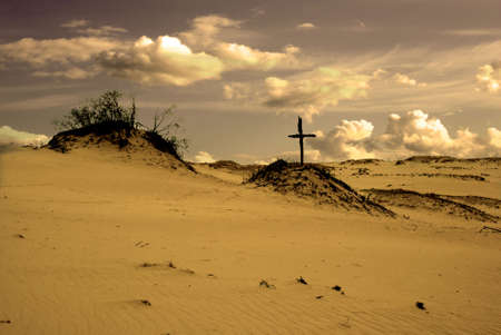 Dunes landscape and old wooden cross, artistic versionの写真素材