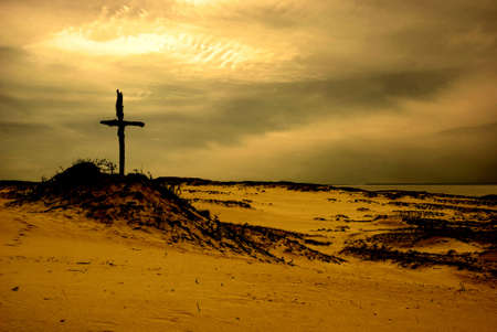 Dunes landscape and old wooden cross, artistic versionの写真素材