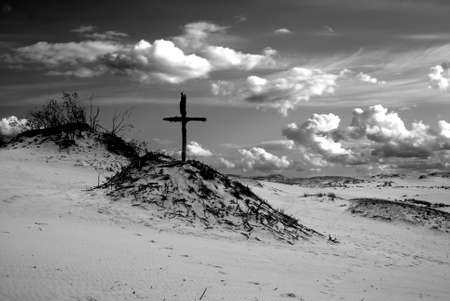 Dunes landscape and old wooden crossの写真素材
