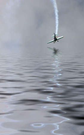 Airplane over the water, reflectionの写真素材
