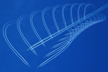 Blue sky with white jet and heartsの写真素材