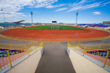 Football field with goal and tablo on blue skyの写真素材