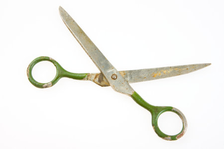 Old metal scissors in his hands. High quality photo