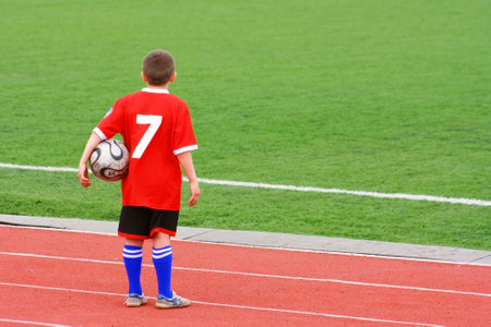 Football field with goal and tablo on blue skyの写真素材