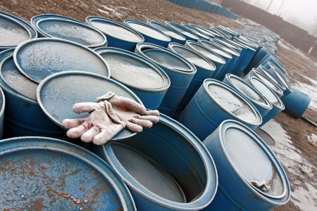 Steel oil rusted barrel tanks stacked in row in a warehouse.front viewの写真素材