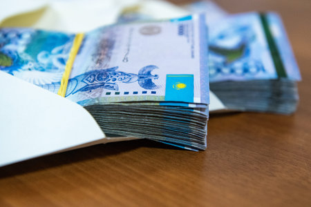Thick wad of money cash on table.