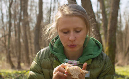 Picnic in the forest. Close up portrait of nice woman on a camp during a spring walk in the forest....