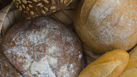 Traditional baked bread in a basket. Natural organic handmade food. Close-up shot. Top view