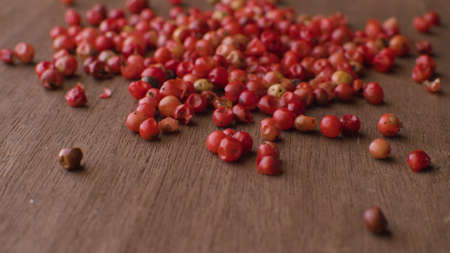 Macro shot of red peppercorns mix - aromatic spice - on the wooden table .. Extreme close upの写真素材