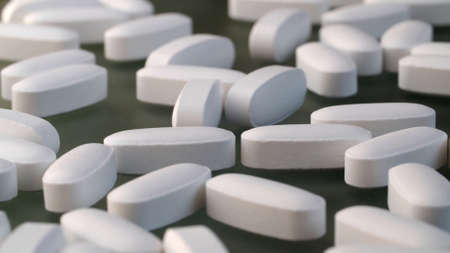 Extreme close up medical tablets and pills on gray background. Healthcare medicaments. Medical drugs...