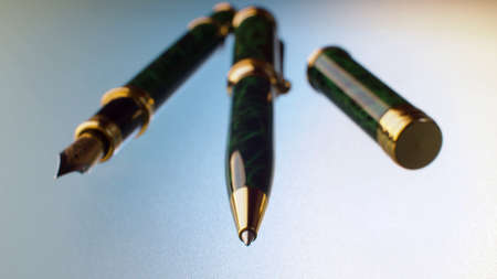 Extreme close up black and green pens on glass table. Ballpoint pen and fountain pen. Macro shotの写真素材