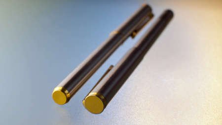 Extreme close up two gray ballpoint pens on glass table. Macro shotの写真素材