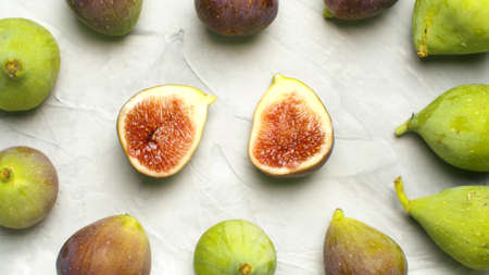 Macro shot ripe figs - whole and halves on the table on white background. Healthy fresh food conceptの写真素材