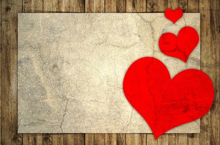 paper and red heart on wooden backgroundの写真素材
