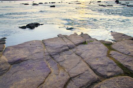 Rushing water flowing over rocksの写真素材