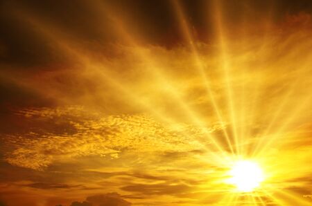 Sunset / sunrise with clouds, light rays and other atmospheric effectの写真素材