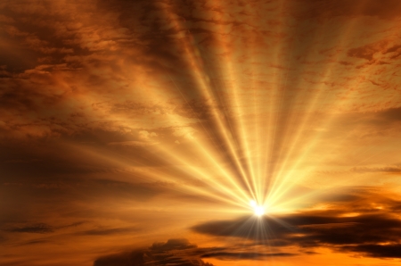 Sunset / sunrise with clouds, light rays and other atmospheric effectの写真素材