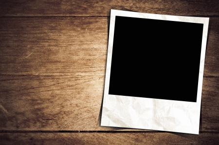 Old photo frame on wood backgroundの写真素材