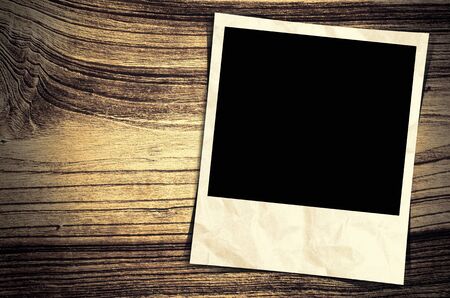 Old photo frame on wood backgroundの写真素材