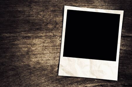 Old photo frame on wood backgroundの写真素材