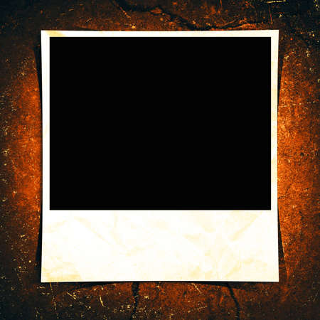 A blank instant photo taped to a grunge background.の写真素材