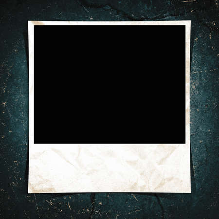 A blank instant photo taped to a grunge background.の写真素材