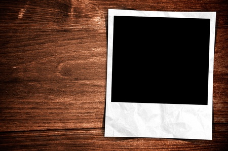 Old photo frame on wood backgroundの写真素材