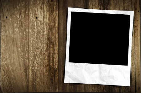 Old photo frame on wood backgroundの写真素材