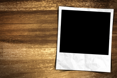 Old photo frame on wood backgroundの写真素材