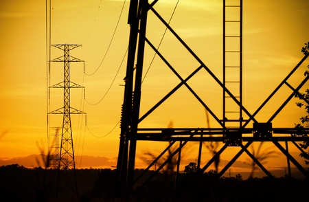 Silhouette of a high voltage postの写真素材
