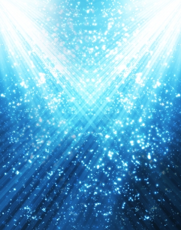 Snow and stars are falling on the background of blue luminous raysの写真素材