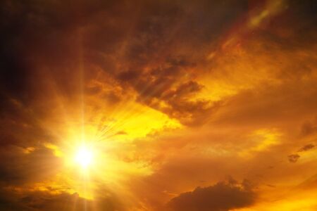 Sunset / sunrise with clouds, light rays and other atmospheric effectの写真素材