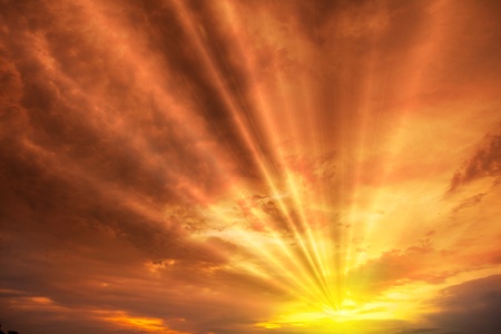 Sunset / sunrise with clouds, light rays and other atmospheric effectの写真素材