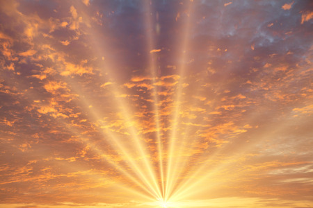 Sunset / sunrise with clouds, light rays and other atmospheric effectの写真素材
