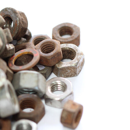 group of old rusty nuts and bolts isolated on white backgroundの写真素材