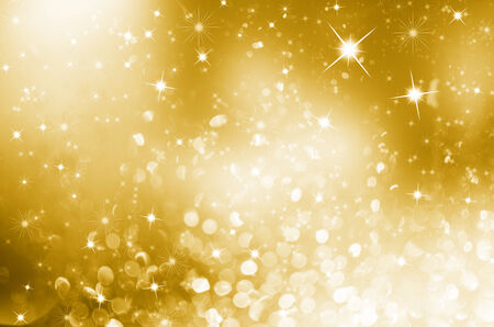 Gold Christmas background with sparkles and stars designの写真素材