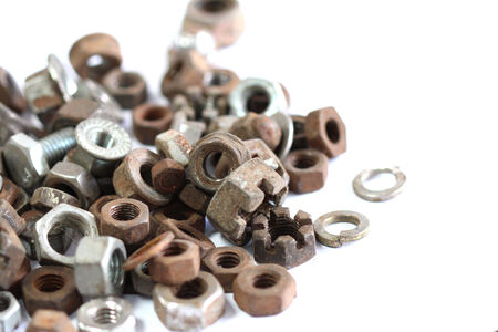 group of old rusty nuts and bolts isolated on white backgroundの写真素材