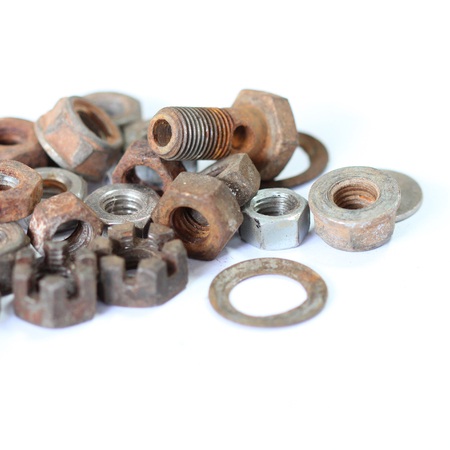 group of old rusty nuts and bolts isolated on white backgroundの写真素材
