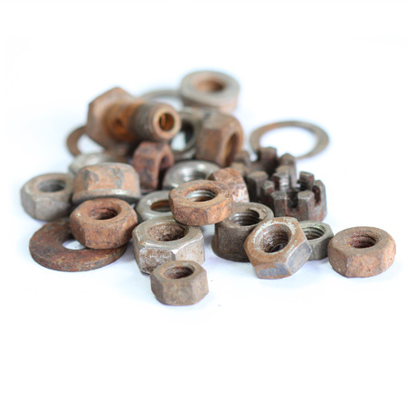group of old rusty nuts and bolts isolated on white backgroundの写真素材