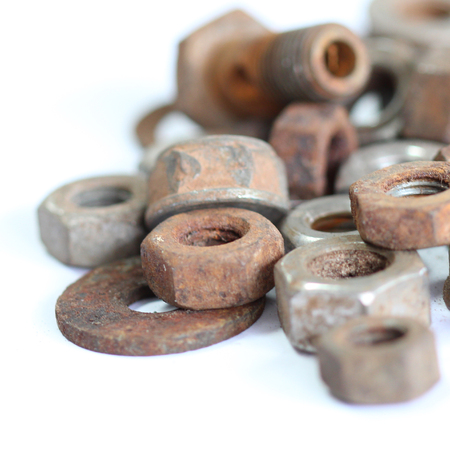 group of old rusty nuts and bolts isolated on white backgroundの写真素材