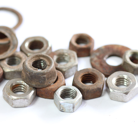 group of old rusty nuts and bolts isolated on white backgroundの写真素材