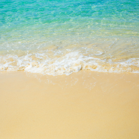 Wave of the sea on the sand beachの写真素材
