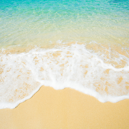 Wave of the sea on the sand beachの写真素材