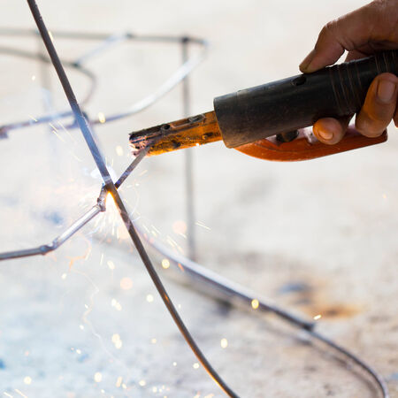 worker use electric welding connecting construction metalの写真素材
