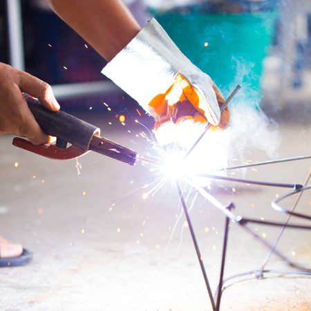 worker use electric welding connecting construction metalの写真素材