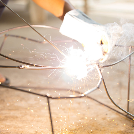 worker use electric welding connecting construction metalの写真素材