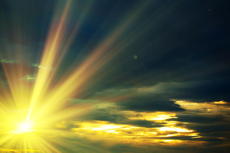 Sunset / sunrise with clouds, light rays and other atmospheric effectの写真素材